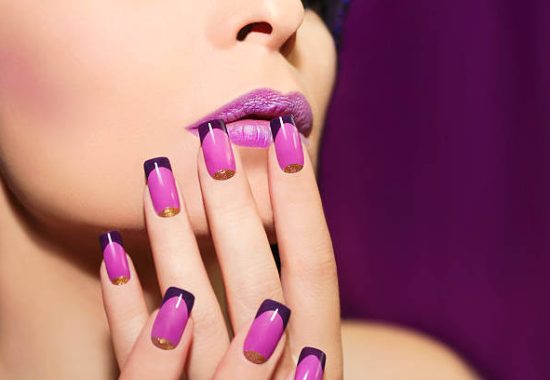 Lilac French manicure for a young woman with purple lips.